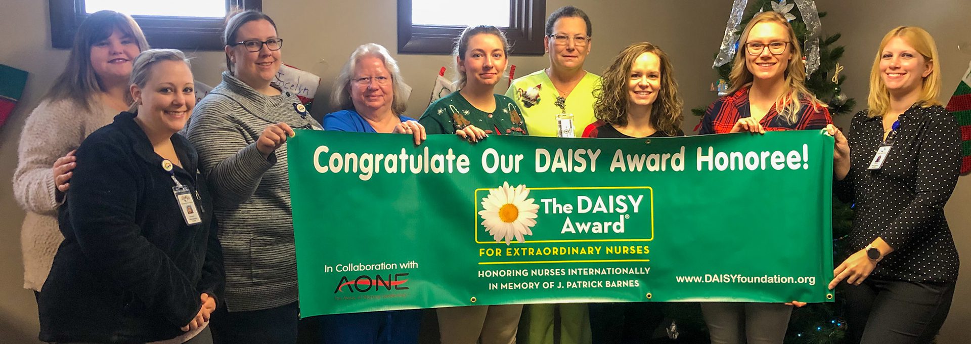 Carterville Nurses with DAISY Award honoree and banner